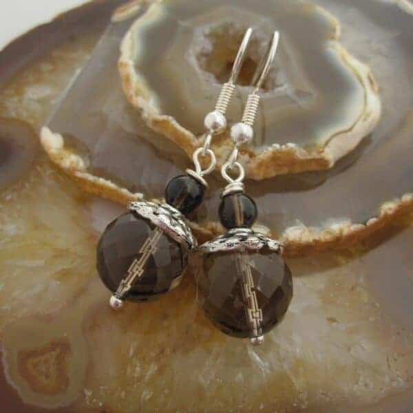 Drop earrings with facet cut smokey quartz and silver plated bead caps. Designed and created in the Isle of Skye.