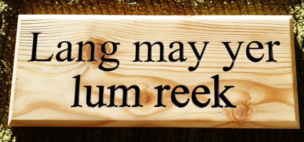Lang may yer lum reek engraved on a wooden plaque